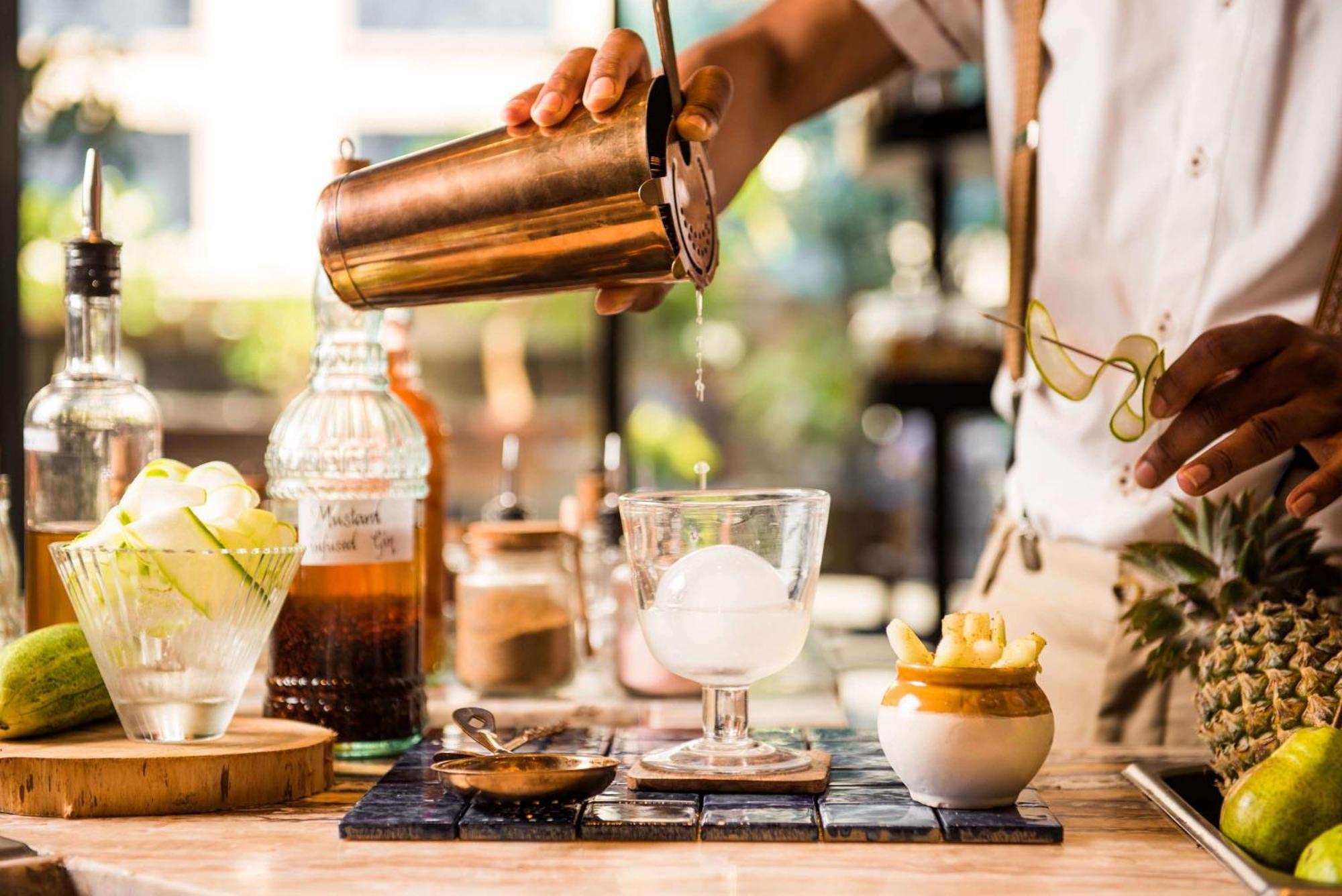 Hyatt Centric Candolim Goa Exterior foto A bartender preparing a cocktail
