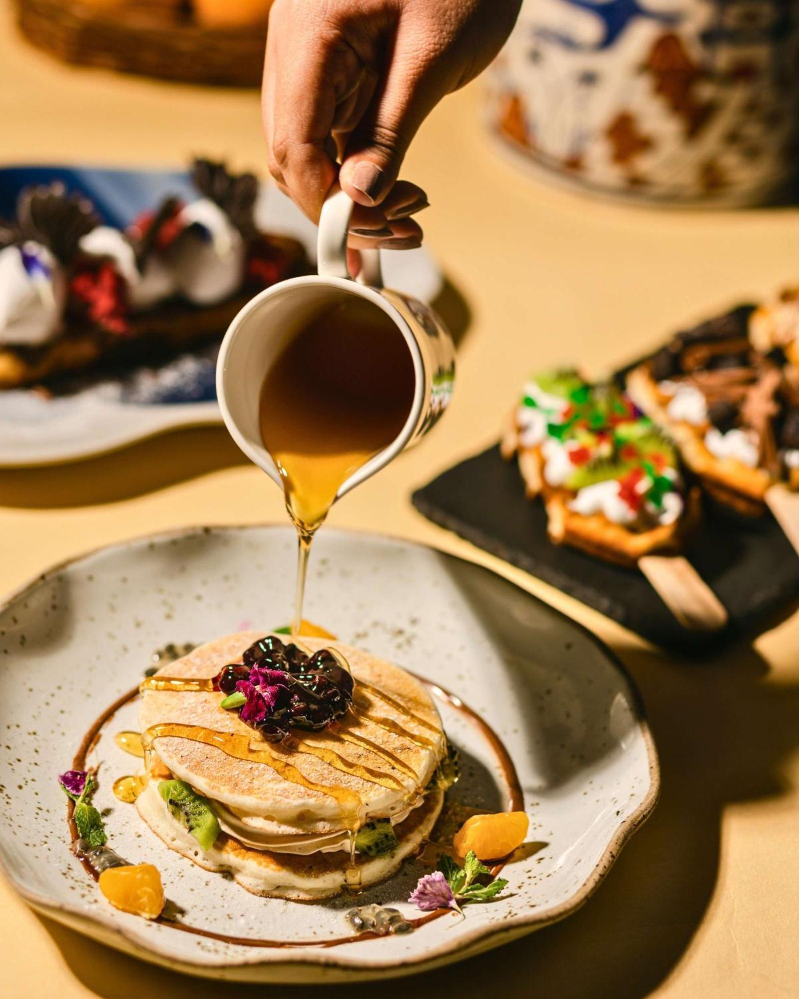 Hyatt Centric Candolim Goa Exterior foto Maple syrup being poured onto a pancake